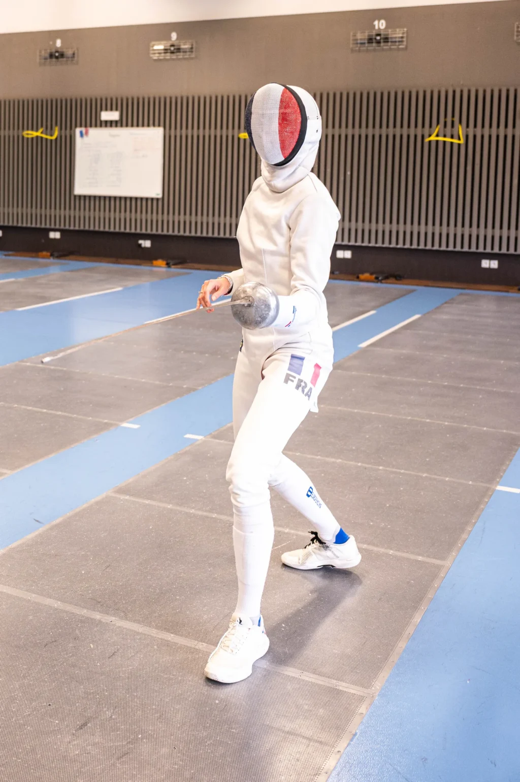 Auriane Mallo masquée, en garde dans la salle d'armes